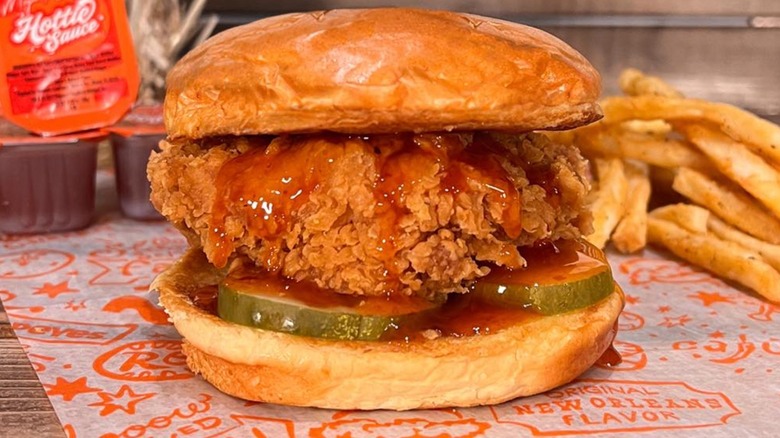 Popeyes chicken sandwich with fries and sauce
