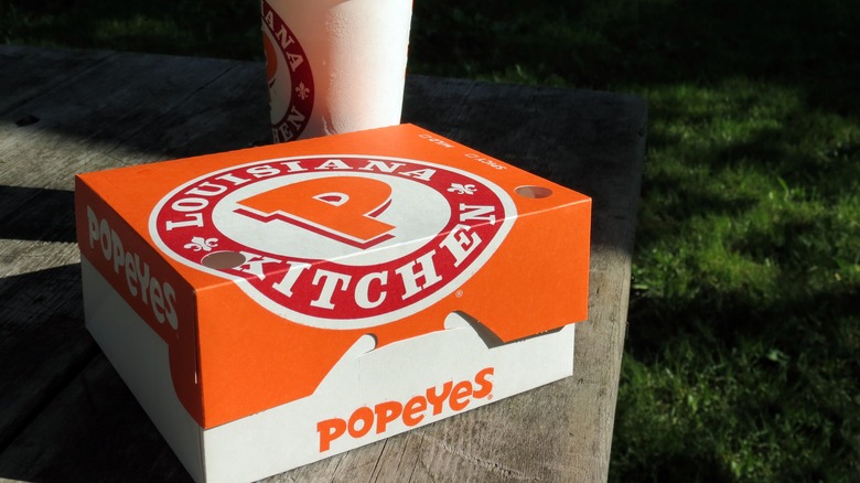 Popeyes burger and a cup