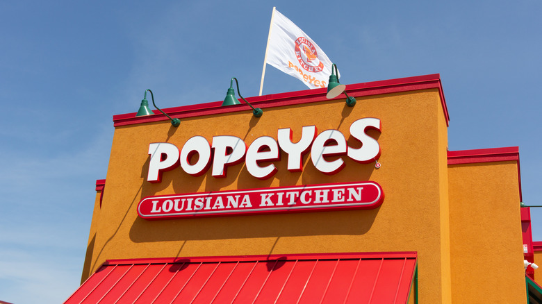 Popeyes storefront sign and flag