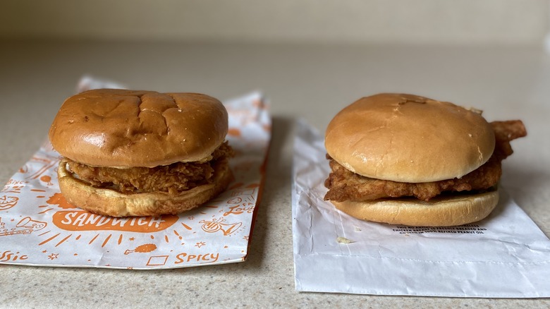 Popeyes and Chick-fil-A sandwiches on counter