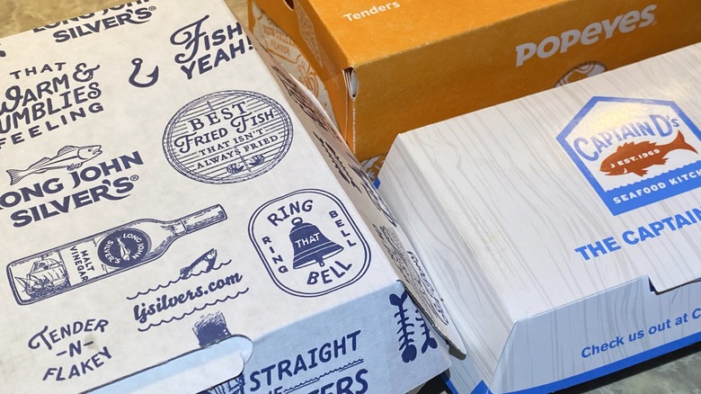 Long John Silver's, Popeyes, and Captain D's takeout containers side by side