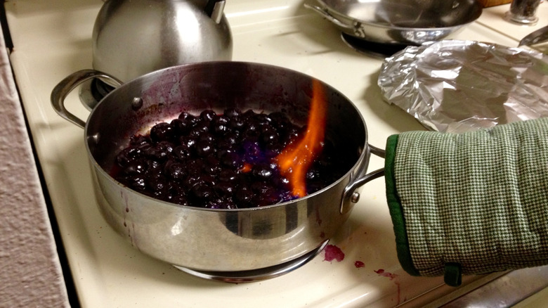 Pot of cherries being flambéed