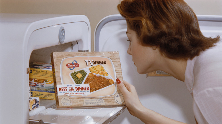 Woman holding a frozen Swanson TV dinner