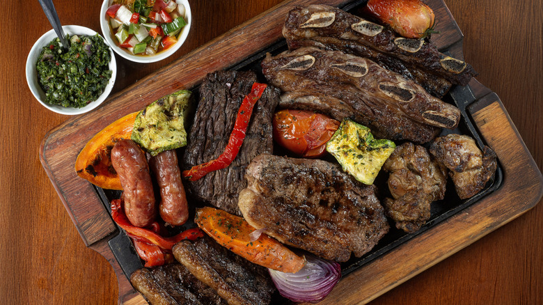 Slicing cooked picanha with a knife and tongs