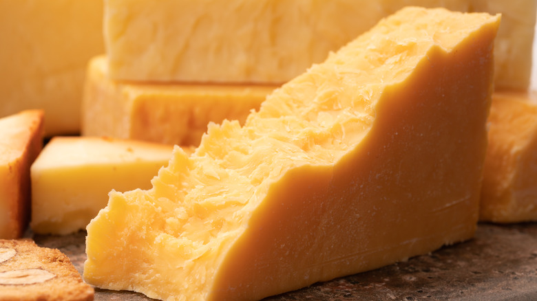 A block of yellow cheddar cheese