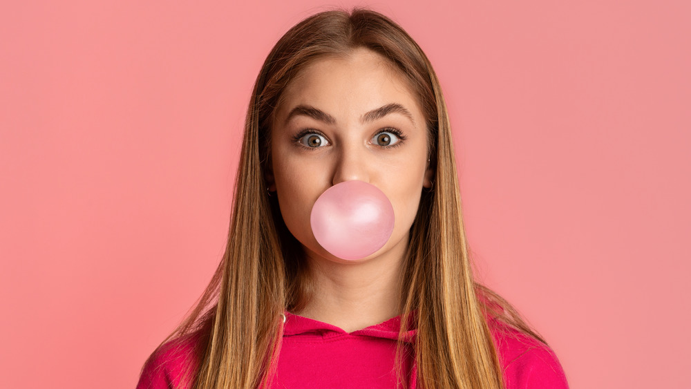 girl blowing bubble with gum