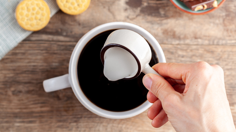 pouring creamer in cup