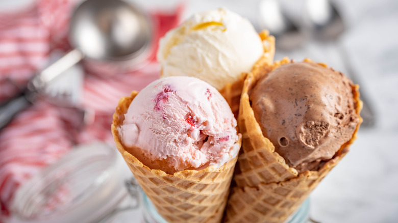 Chocolate, strawberry, and vanilla ice cream in waffle cones