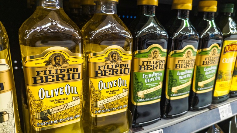 Bottles of Filippo Berio olive oils on supermarket shelves.