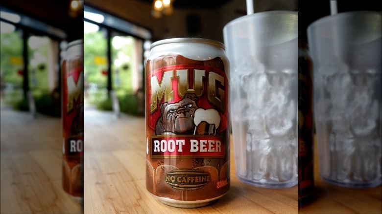 Can of Mug Root Beer on counter with cup of ice