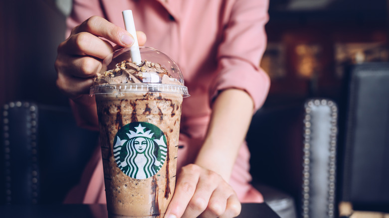 A person holding a Frappuccino