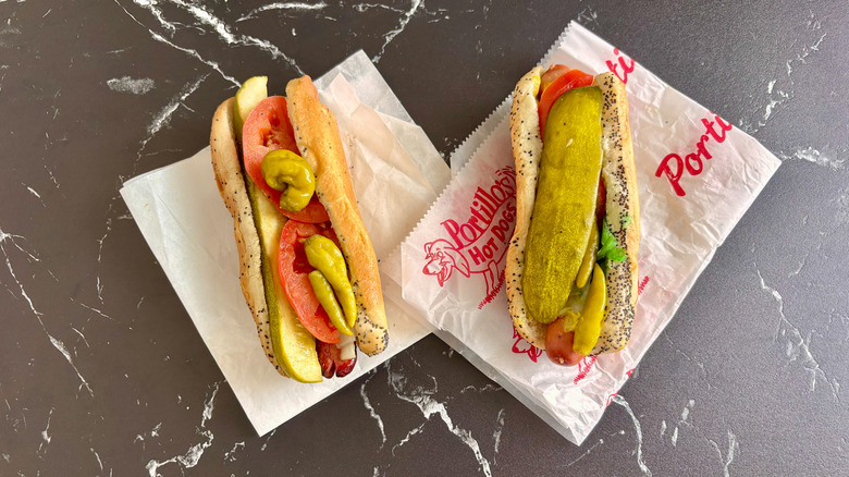 Two Chicago-style hot dogs on countertop