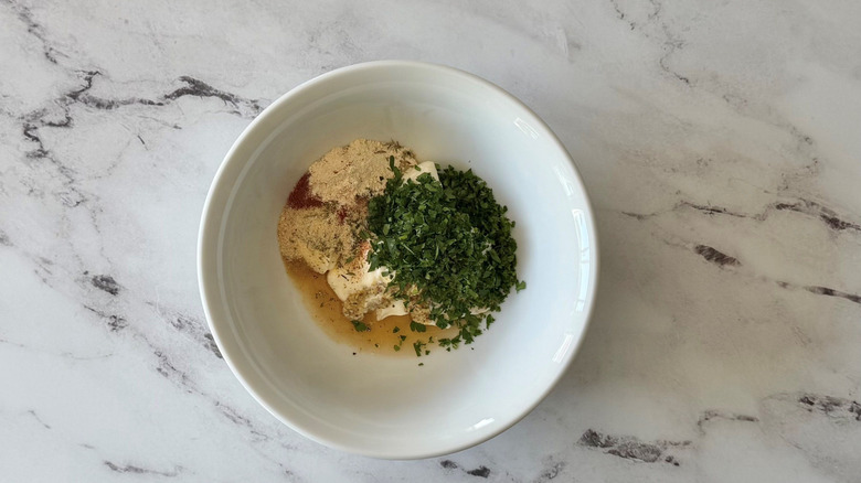 Unmixed potato salad dressing ingredients in bowl