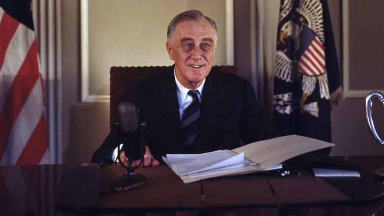 Franklin D. Roosevelt sitting at presidential desk in the White House