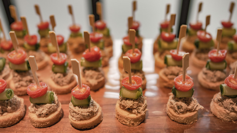 Tomato mousse appetizers with skewers through them.