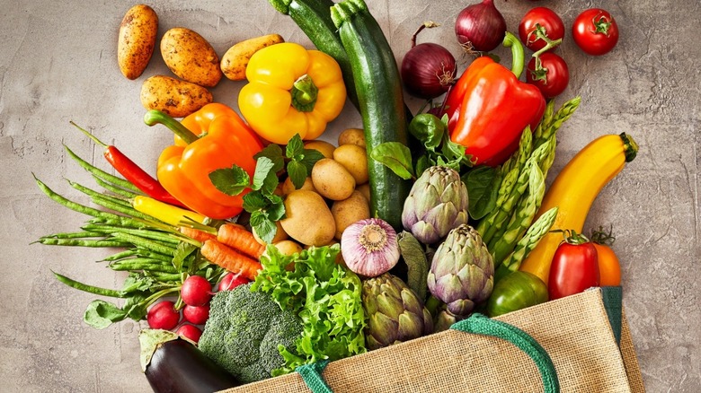 Fruits and vegetables spilling out of bag