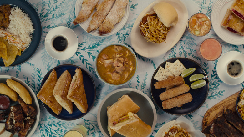 lots of different foods plated on a floral table cloth