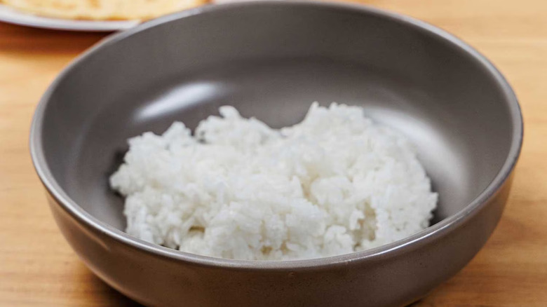 Sam's Club Member's Mark Jasmine Rice in a bowl on a table with a spoon full of rice
