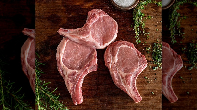 Sam's Club Member's Mark pork chops on a table next to salt and other seasonings