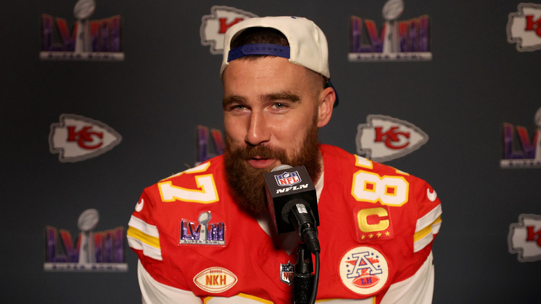 Travis Kelce talking into microphone