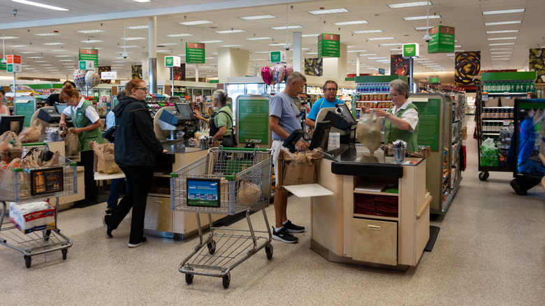 View of Publix registers bustling with shoppers in a clean, busy store