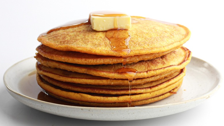 stack of pancakes with butter and syrup