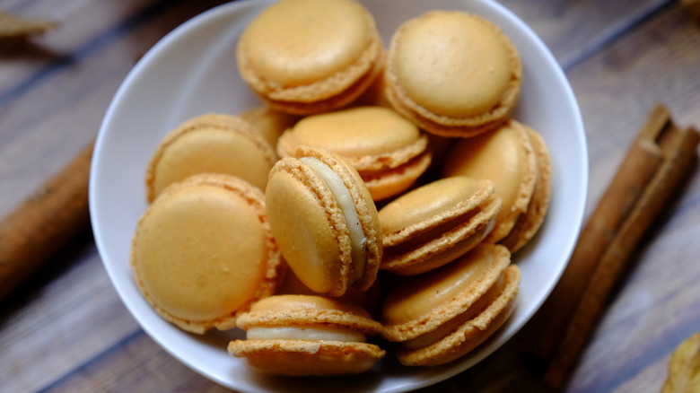 pumpkin spice macarons in bowl