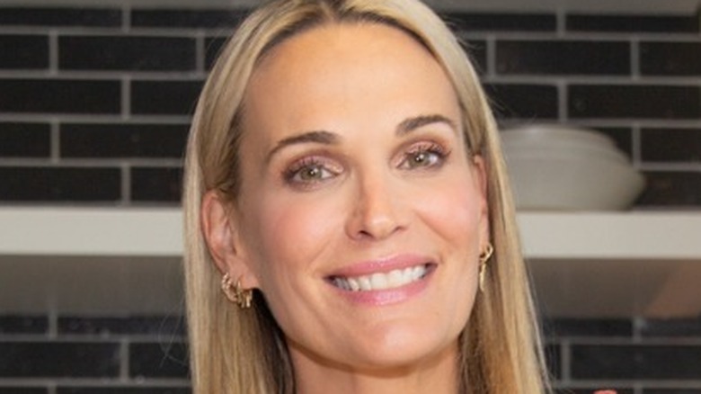 Molly Sims in kitchen holding cottage cheese
