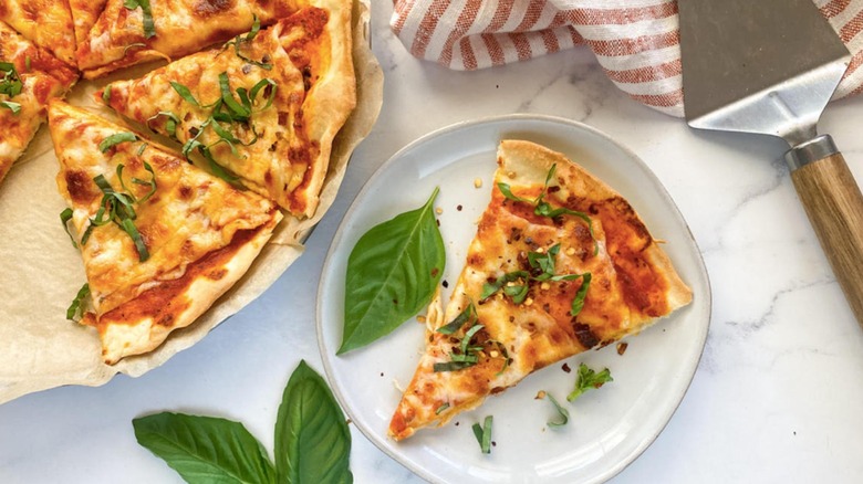 thin crust pizza with cheese and basil