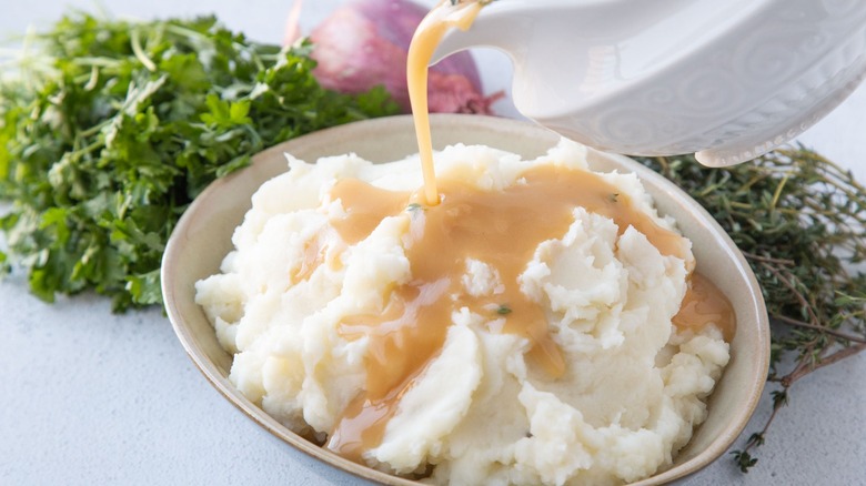 gravy pouring onto mashed potatoes
