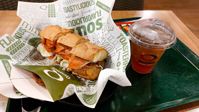 Quiznos sandwich with a drink