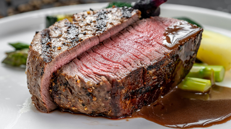 A juicy, pink steak cut in half