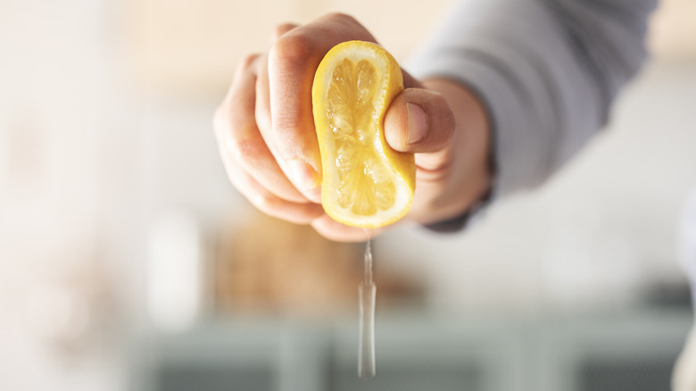 Hand squeezing lemon