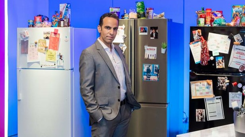 Dan Ahdoot next to refrigerators