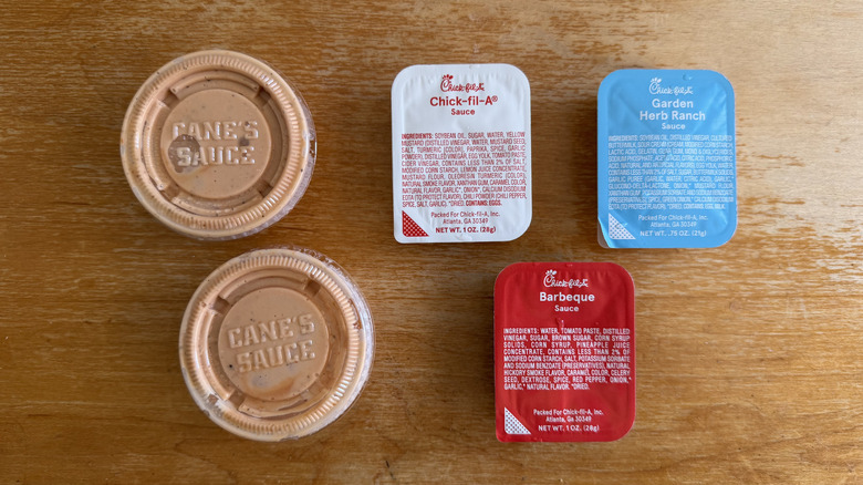 Overhead view of various dipping sauces from Raising Cane's and Chick-fil-A
