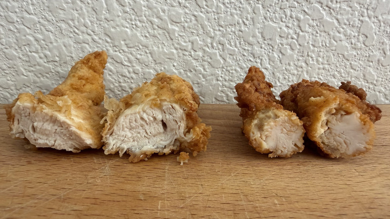 A chicken tender from both Raising Cane's and Chick-fil-A cut in half