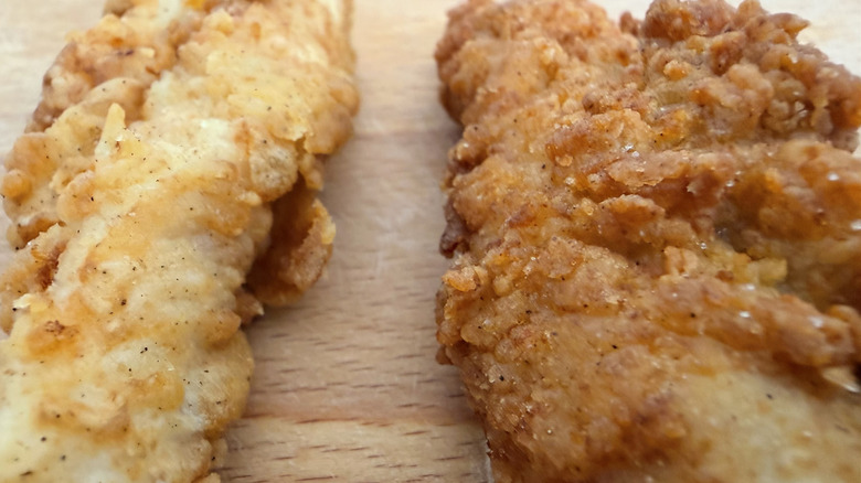 Close-up of one of each tender from Raising Cane's and Chick-fil-A