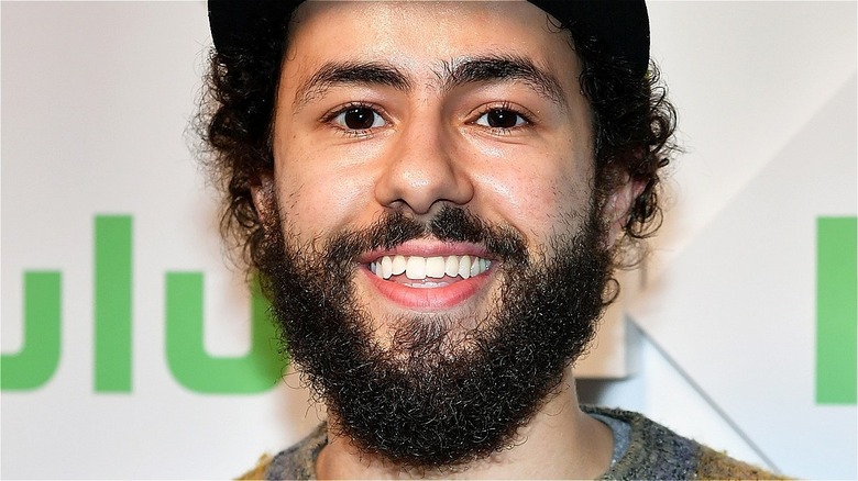 Ramy Youssef flashing toothy smile