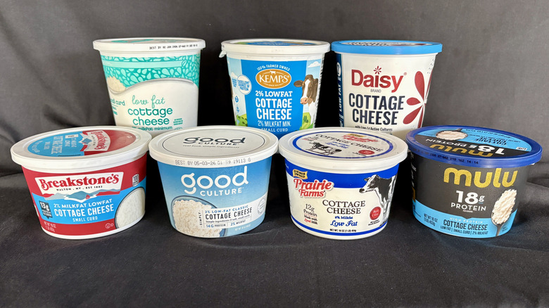 various tubs of cottage cheese on black background