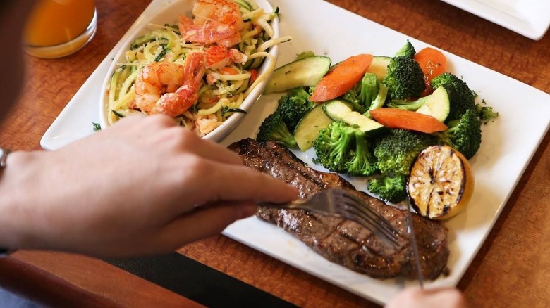 a diner cuts into a steak