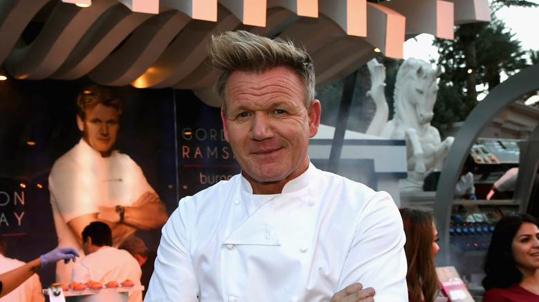 Gordon Ramsay in chef's jacket with arms crossed