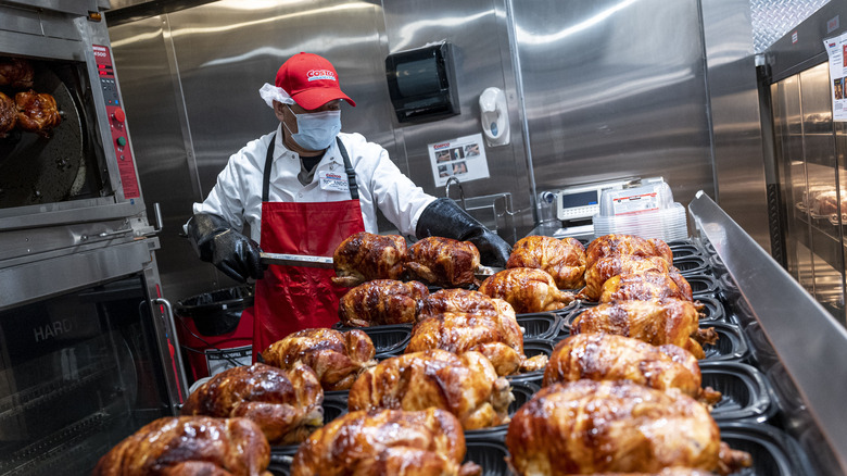 Worker with rotisserie chickens