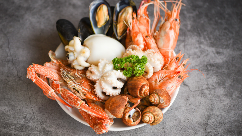 Plate of crab legs and clams on counter