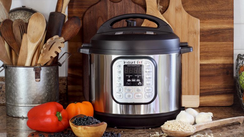 Instant Pot on counter with beans and rice