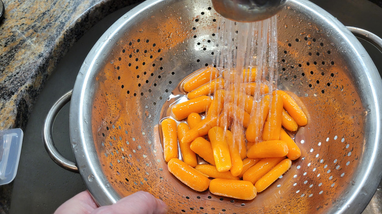 rinsing baby carrots in strainer