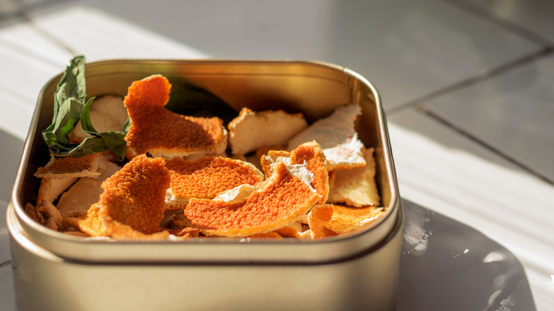 Orange peels in a silver container