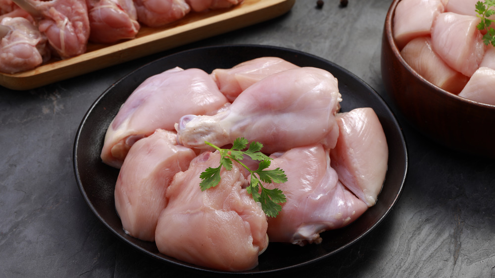 Raw chicken in a bowl with cilantro