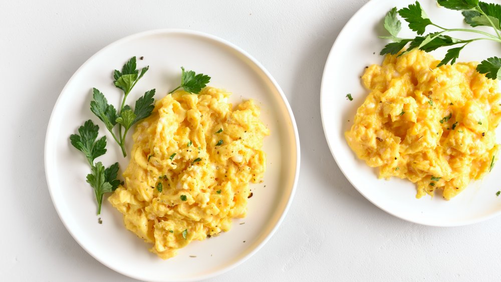 Two plates of scrambled eggs