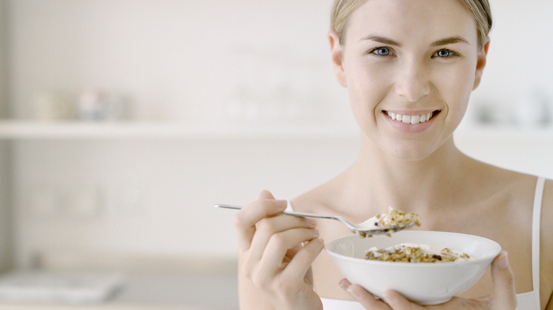 smiling woman eating cereal