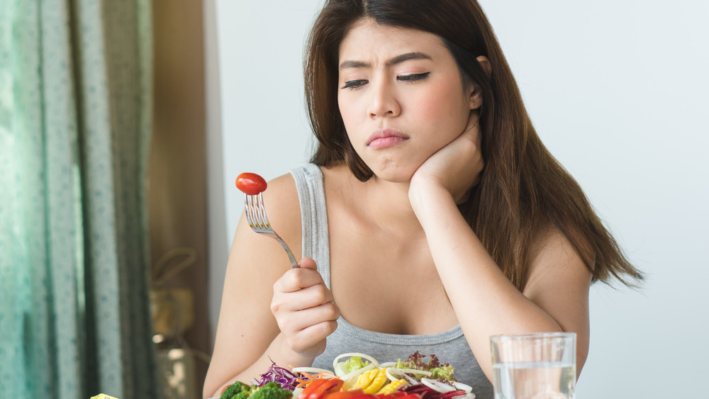 Woman eating vegetables